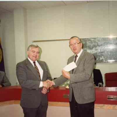 John Dawson of Lions Club presenting check to Pat Norton to purchase a telephone device for the deaf on Nov. 17,1988.