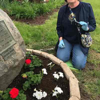 Beverly Blankertz planting flowers