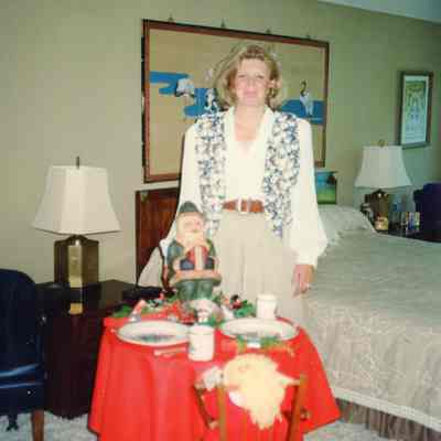 Garden Member standing by her Holiday table display.