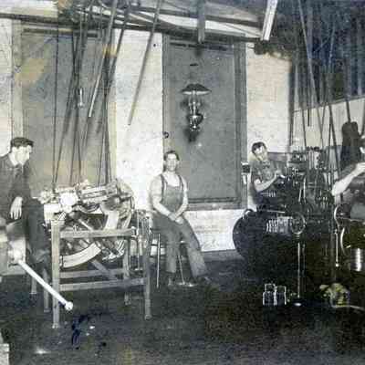 Men on machinary, Bradt Warner is in middle of photo.
