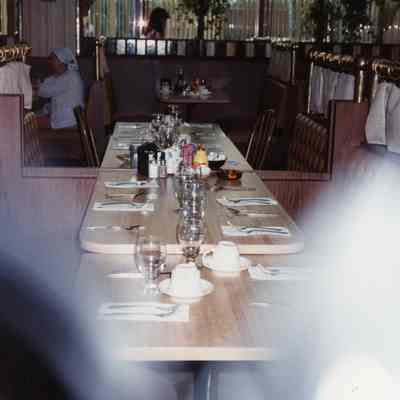 Showing glass doors opened to make one long table for party. Extra tables at each end.