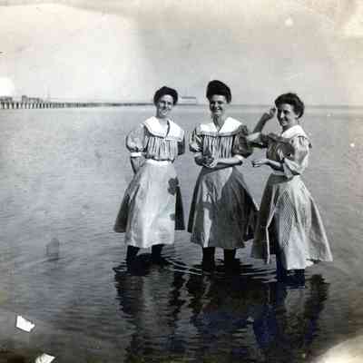 Three women swimming.