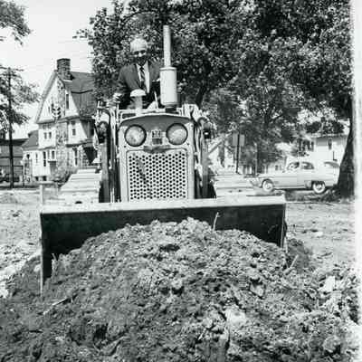 Dr. Carpenter breaking ground for new hospital, May 1965. Hosie House in Background