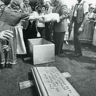 Preparing time capsule. Manny Lentine on left
