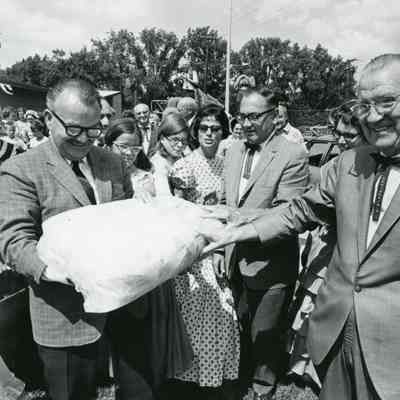 Preparing time capsule. Manny Lentine on left