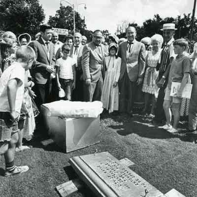 Preparing time capsule. Manny Lentine on left