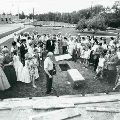 Preparing time capsule. Manny Lentine on left