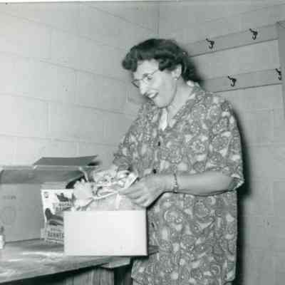 Mrs. Letha A. Rice opening orchids, 'Our Town' Play Cast at the After Party on March 05, 1953.