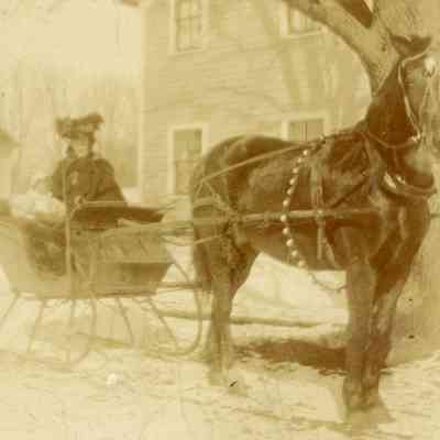 Ruth Murphy at 1 yrs old and Mae Murphy on North side of Brush St and 2nd St in 1900. Horse and sleigh.