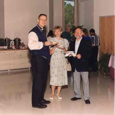 Father Ray Bucon, Susan and Ed Rowe