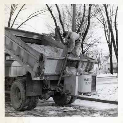 D.P.W worker salting the road.