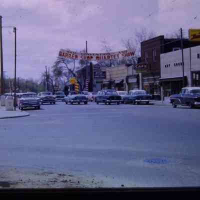 Barbershop banner over Wayne road near Glenwood, lookikng South. Northside hardware at right.