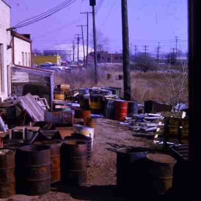 Alleys behind Michigan Ave EB businesses, east of town. South Side. Merriman Water tanks visible.