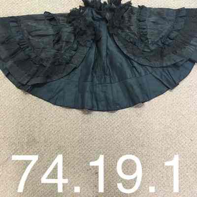 Short black taffeta cape.