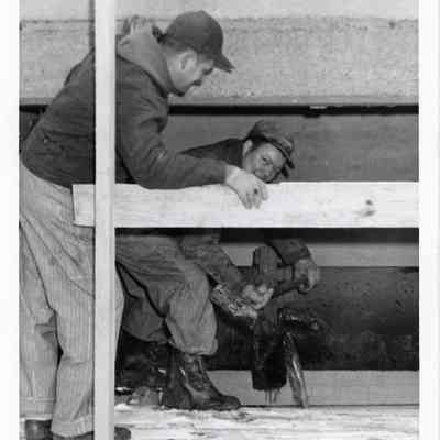 Earl Jacobs and Alvin Butler working on the sewer pipe.