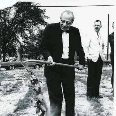 Matthew Tinkham Sr shoveling the first shovel of dirt on Michigan Ave. Dick Riley is in background.