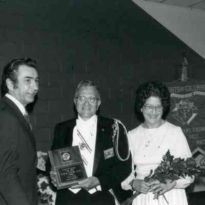 May 1982. Grand Knight Ray Solososh presenting Knight of Year Award to B.G.R. Louis Gladswise & wife Agnes