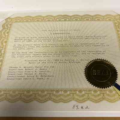 Commemoration: 89.4.1 A Commemoration 8-1/2 inches Given to Henry Goudy , Wayne  Historical Museum Curator for the use of the Museum on Tuesday April 19, 1988 for a historic council meeting . It was presented to Henry Goudy on Tuesday March 21, 1989 by the mayor Patrick j Norton. The commemoration had the seal of Wayne mi on it.