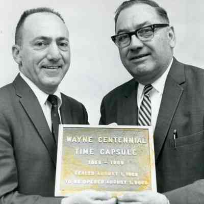 Preparing time capsule. Manny Lentine on left, Ken McKay on right