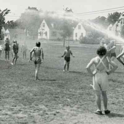 Kids playing with hose water