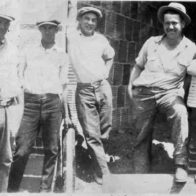 Workers on site laying bricks for theater, 1927