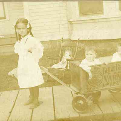 Hazel Cozadd pulling Wagon with Ruth Murphy and Marion Cozaad in it in about 1901.
