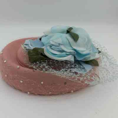 Pink hat and blue floral piece.