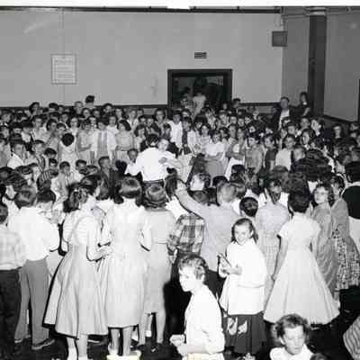 A Group of People Standing Around Two People Dancing