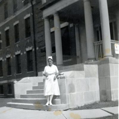 Nurse Monica Eckert in front of K Building