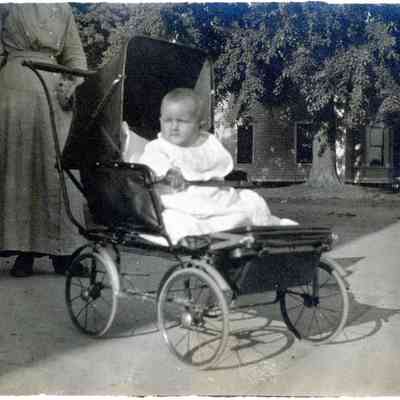 A child in baby carrage.