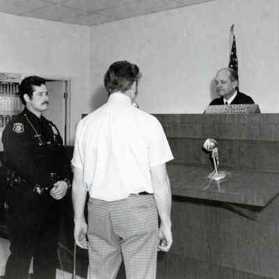 Patrolman Pat Kenny with suspect in Judge Seiler Court Room