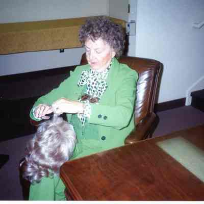 Mrs. Seraphia Moore combing a wig she donated on 09/15/1991.