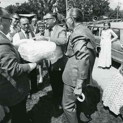 Preparing time capsule. Manny Lentine on left
