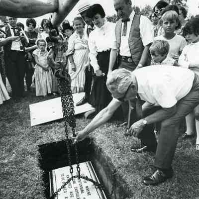 Burying time capsule. Manny Lentine center with tie