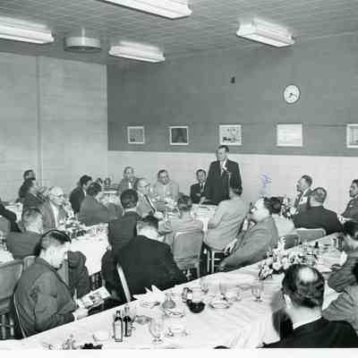 J.J. Kaye Adressing Meeting. Larry Ladd at far left, Clarence Woolf marked