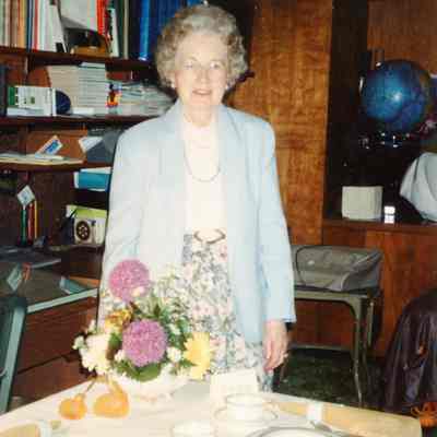 Garden Club Member standing by her table display.