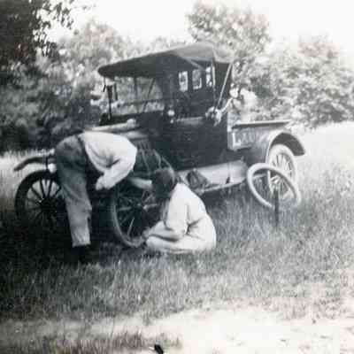 People fixing a tire on the Laundry car.