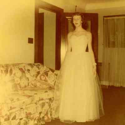 A standing Pat Millar in white formal.