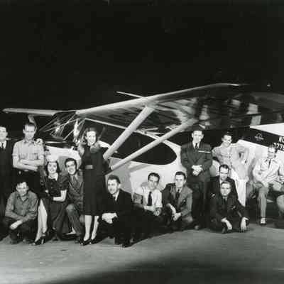 Stinson Employees standing in front of an airplane