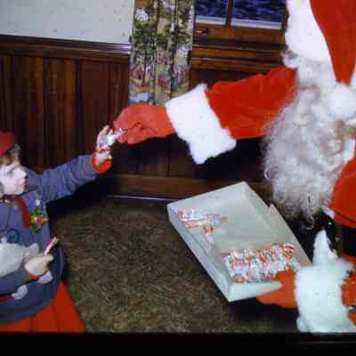 Child receiving gift from santa