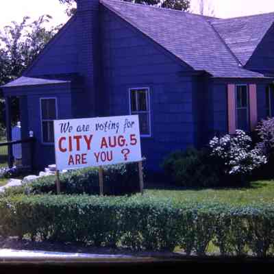 Home with Sign in Yard