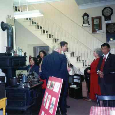 Mayor Warfield, Donna McEachern and people from the Philipines looking at Museum displays.