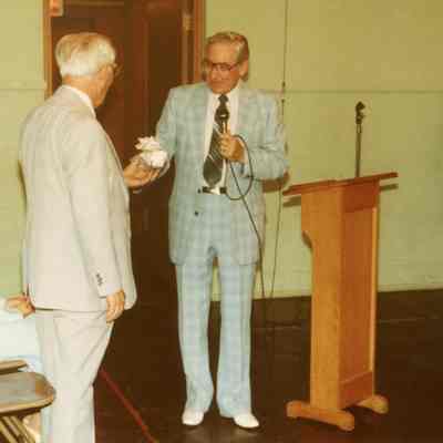 Rev. Jacobs presents gift to Ben Whaley at Reception for the Whaley's on June 6, 1982. Vanessa Whaley is sitting. Gladwin: Miller (Lay Leader) in background
