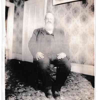 Photo - Man sitting in chair