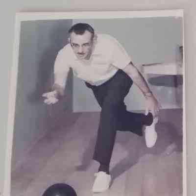 A picture of Phil Versace rolling a bowling ball in a bowling alley