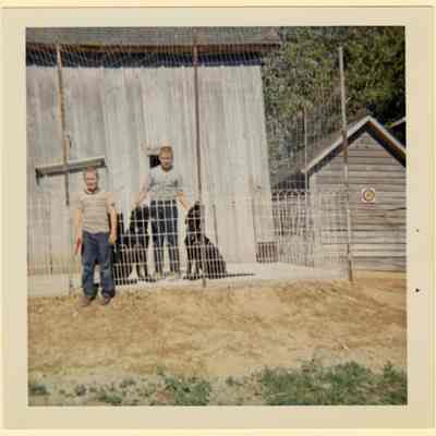 Frank and Brian Eul by barn, C. 1960s