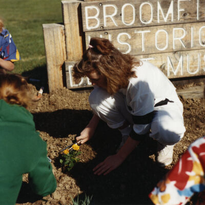 Kids Planting Near the Broomfield Historical Depot Sign