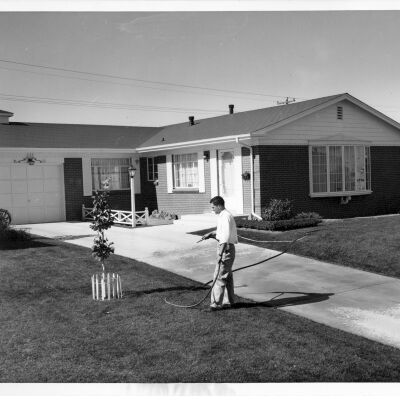 Man Watering the Lawn at a New Home