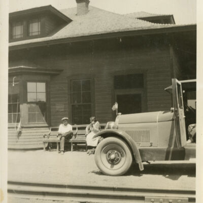 Jeanie Malott Hillen and Waiting Man by a Davis Automobile at Superior Train Depot
