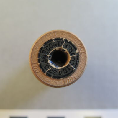 Close up of text on spool.: Origsize: 1" (h) x 0.75" (diam; Origformat: Artifact